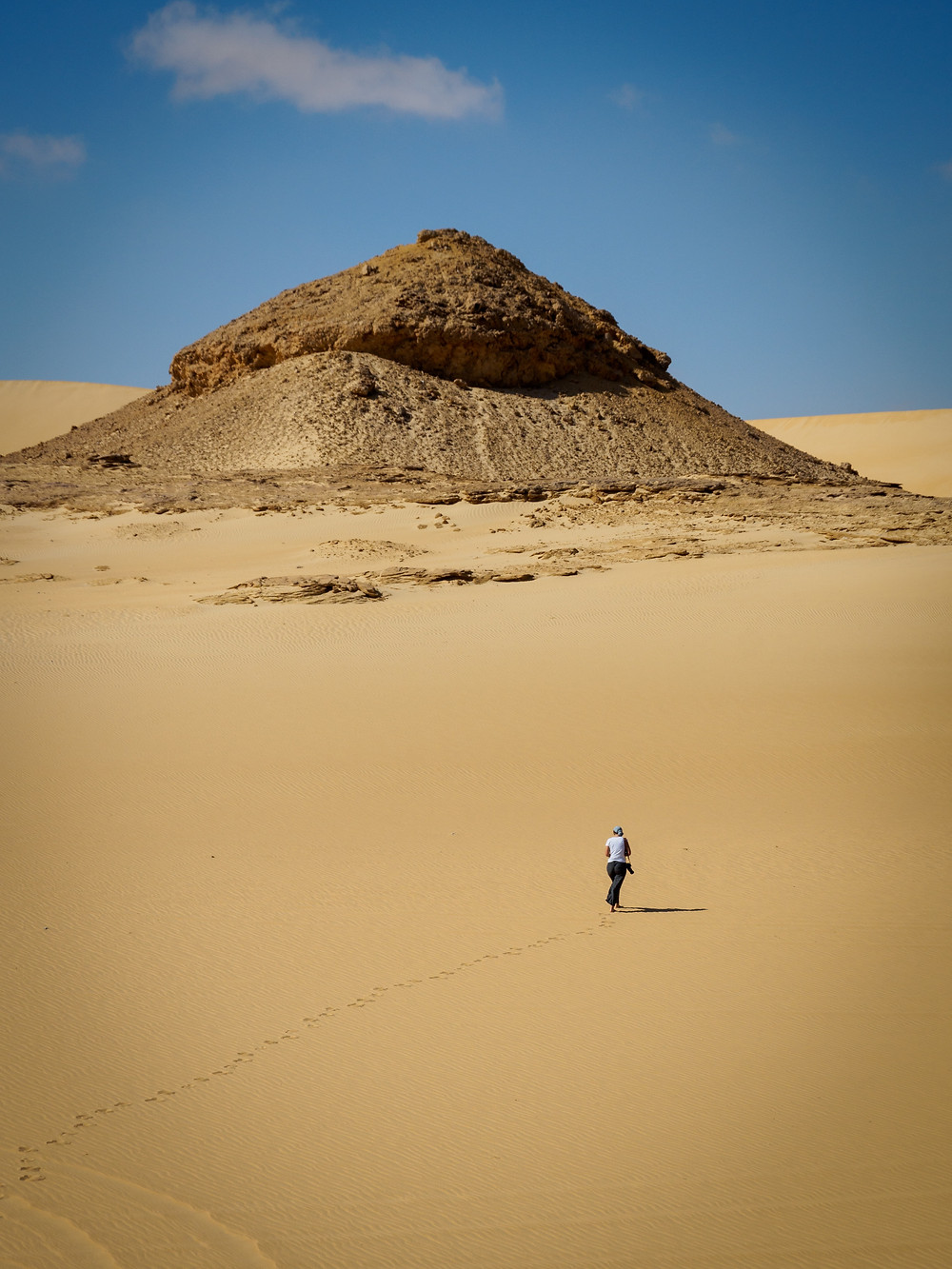 Person walks alone in desert.