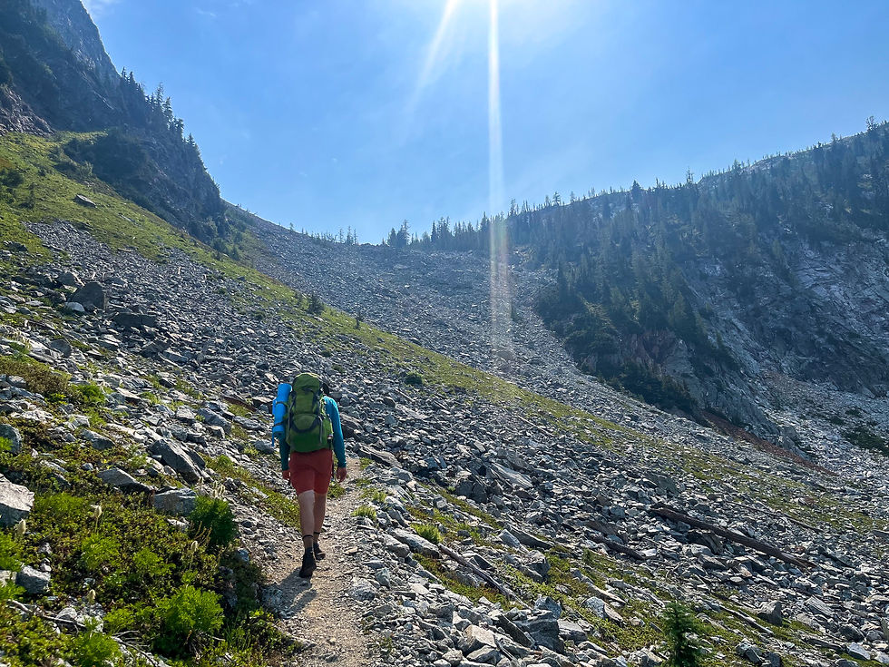 Backpacker going up Rainbow Pass in North Cascades NP